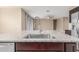 Granite countertops with a sink, stainless steel appliances, and an open view of a living space at 30303 W Whitton Ave, Buckeye, AZ 85396
