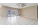 Bright, open living space with tile flooring, large sliding glass doors, and modern ceiling fan at 30303 W Whitton Ave, Buckeye, AZ 85396
