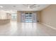 Bright, open living space with tile flooring, large sliding glass doors, and modern ceiling fan at 30303 W Whitton Ave, Buckeye, AZ 85396