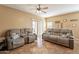 Comfortable living area with tile flooring, neutral paint, and sliding glass door to backyard at 33425 N Roadrunner Ln, San Tan Valley, AZ 85144