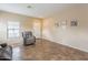 Neutral living room with tile flooring, large window and comfortable seating at 33425 N Roadrunner Ln, San Tan Valley, AZ 85144