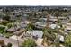 An aerial view of a residential area with lush trees and foliage, highlighting a home with a private pool at 4134 N 35Th St, Phoenix, AZ 85018