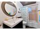 Bathroom featuring a round mirror, and a bathtub with white and polka-dot shower curtain at 4134 N 35Th St, Phoenix, AZ 85018