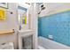 Compact bathroom features blue tiling, a modern sink, and a shower, designed for functionality and style at 4134 N 35Th St, Phoenix, AZ 85018