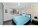 Comfortable bedroom with gold accent wall, a large window offering bright outdoor views, and modern interior design at 4134 N 35Th St, Phoenix, AZ 85018