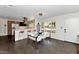 Contemporary dining area with a glass table, white chairs, and an open view into the modern kitchen and stylish decor at 4134 N 35Th St, Phoenix, AZ 85018