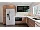 Stylish kitchen features modern appliances, sleek cabinetry, and a minimalist design with bright white countertops at 4134 N 35Th St, Phoenix, AZ 85018