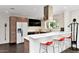 Sleek kitchen features a breakfast bar with red chairs, stainless steel appliances, and modern cabinetry and hardware at 4134 N 35Th St, Phoenix, AZ 85018