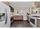 Modern kitchen with wood cabinets, stainless steel appliances, white countertops, and views of lush backyard at 4134 N 35Th St, Phoenix, AZ 85018