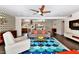 Bright living room with a colorful rug, contemporary furniture, and an open layout connecting to the dining area at 4134 N 35Th St, Phoenix, AZ 85018