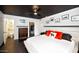 Well-lit main bedroom showcasing modern decor, an organized walk-in closet, and a view into the ensuite bathroom at 4134 N 35Th St, Phoenix, AZ 85018