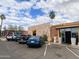 Exterior view of Postino restaurant featuring a stone wall and parked cars at 4134 N 35Th St, Phoenix, AZ 85018
