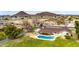 Aerial shot showcasing the backyard with pool, covered patio, spacious lawn, and the layout of the property at 4211 W Yorkshire Dr, Glendale, AZ 85308