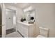Bright bathroom with white cabinets, modern lighting, and gray flooring at 4211 W Yorkshire Dr, Glendale, AZ 85308