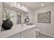 Bright bathroom with white cabinets, modern lighting, and neutral decor at 4211 W Yorkshire Dr, Glendale, AZ 85308