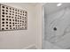Bathroom shower with modern tile, and brushed metal fixtures at 4211 W Yorkshire Dr, Glendale, AZ 85308