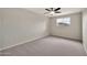 Bright bedroom with neutral walls, gray carpet, one window, and ceiling fan at 4211 W Yorkshire Dr, Glendale, AZ 85308