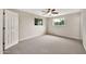 Bright bedroom with neutral walls, gray carpet, two windows, and ceiling fan at 4211 W Yorkshire Dr, Glendale, AZ 85308