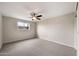 Bright bedroom with neutral walls, gray carpet, one window, and ceiling fan at 4211 W Yorkshire Dr, Glendale, AZ 85308