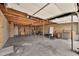 Spacious two-car garage with exposed beams and brick walls providing ample storage space and functionality at 4211 W Yorkshire Dr, Glendale, AZ 85308