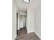 Bright hallway with grey wood-look tile, closet, and access to a bathroom with unique glass block shower at 4211 W Yorkshire Dr, Glendale, AZ 85308