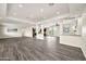 Spacious living room with wood-look floors flows to the kitchen at 4211 W Yorkshire Dr, Glendale, AZ 85308