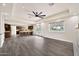 Spacious and open living area with a ceiling fan, tile flooring, and access to outdoor patio at 4211 W Yorkshire Dr, Glendale, AZ 85308