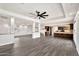 Open-concept living space seamlessly connecting the living area and kitchen, featuring a stylish ceiling fan at 4211 W Yorkshire Dr, Glendale, AZ 85308