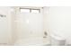 Bright bathroom featuring a tub with white surround and a toilet at 43857 W Bedford Dr, Maricopa, AZ 85138