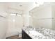 Updated bathroom with a shower-over-tub combination, granite countertop, and a large mirror at 43857 W Bedford Dr, Maricopa, AZ 85138