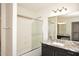 Well-lit bathroom with granite countertop, sleek vanity, and tub-shower combo at 43857 W Bedford Dr, Maricopa, AZ 85138