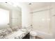 Modern bathroom featuring granite countertop, ample mirror and a shower over tub at 43857 W Bedford Dr, Maricopa, AZ 85138
