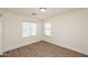 This spacious bedroom has wood floors and large windows at 43857 W Bedford Dr, Maricopa, AZ 85138