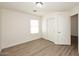 This light bedroom has wood floors and sliding door closet at 43857 W Bedford Dr, Maricopa, AZ 85138