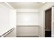 Walk-in closet with custom built-in shelving and a hanging rod at 43857 W Bedford Dr, Maricopa, AZ 85138