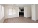 Inviting dining room with wood-look floors, a chandelier, and a glimpse of the kitchen at 43857 W Bedford Dr, Maricopa, AZ 85138