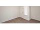 Bright entryway with wood-look floors, a white door, and a window with blinds at 43857 W Bedford Dr, Maricopa, AZ 85138
