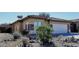 Charming single-story home featuring desert landscaping, a tiled roof, and a two-car garage at 43857 W Bedford Dr, Maricopa, AZ 85138