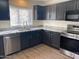 Modern kitchen features stainless steel appliances, granite countertops, and dark wood cabinets at 43857 W Bedford Dr, Maricopa, AZ 85138