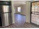 Bright living room view showing vinyl floors and new paint at 43857 W Bedford Dr, Maricopa, AZ 85138