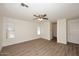 Bright living room featuring vinyl flooring and a modern ceiling fan at 43857 W Bedford Dr, Maricopa, AZ 85138