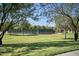 Well-maintained tennis courts surrounded by mature trees and lush green landscaping at 43857 W Bedford Dr, Maricopa, AZ 85138