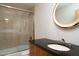 Bathroom showcasing a glass shower, modern vanity, and a round decorative mirror at 4550 E Foothill Dr, Paradise Valley, AZ 85253