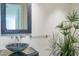 Contemporary bathroom with bowl sink, decorative mirror, and green plant at 4550 E Foothill Dr, Paradise Valley, AZ 85253