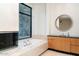 Bathroom with fireplace and soaking tub beneath a window with natural light at 4550 E Foothill Dr, Paradise Valley, AZ 85253