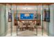 Contemporary dining room featuring a glass enclosed space, a modern light fixture and seating for six at 4550 E Foothill Dr, Paradise Valley, AZ 85253