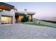 Contemporary home design with a stone driveway and desert landscaping, creating a striking curb appeal at 4550 E Foothill Dr, Paradise Valley, AZ 85253