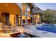 Beautiful home exterior featuring a patio with fire pit, seating, mountain views, and a sparkling pool at 4550 E Foothill Dr, Paradise Valley, AZ 85253