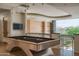 Game room featuring a pool table, bar area and mountain views through large glass windows, perfect for entertaining at 4550 E Foothill Dr, Paradise Valley, AZ 85253