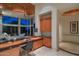 Home office with custom desk, cabinets, and views of the surrounding landscape at 4550 E Foothill Dr, Paradise Valley, AZ 85253